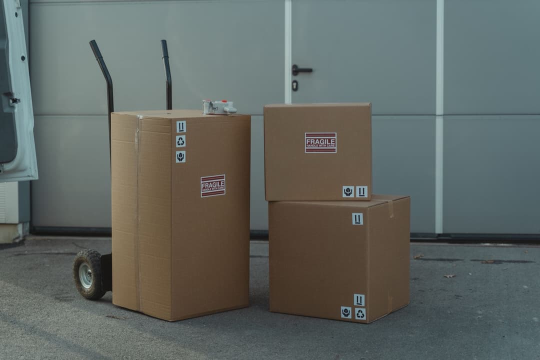 Small cardboard parcels stacked on the ground, the kind of low-value shipment the $800 de minimis exemption used to cover