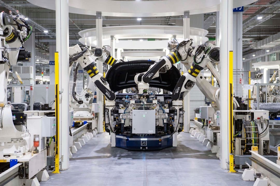 Automotive components moving along a factory assembly line, illustrating auto parts subject to a Section 232 tariff