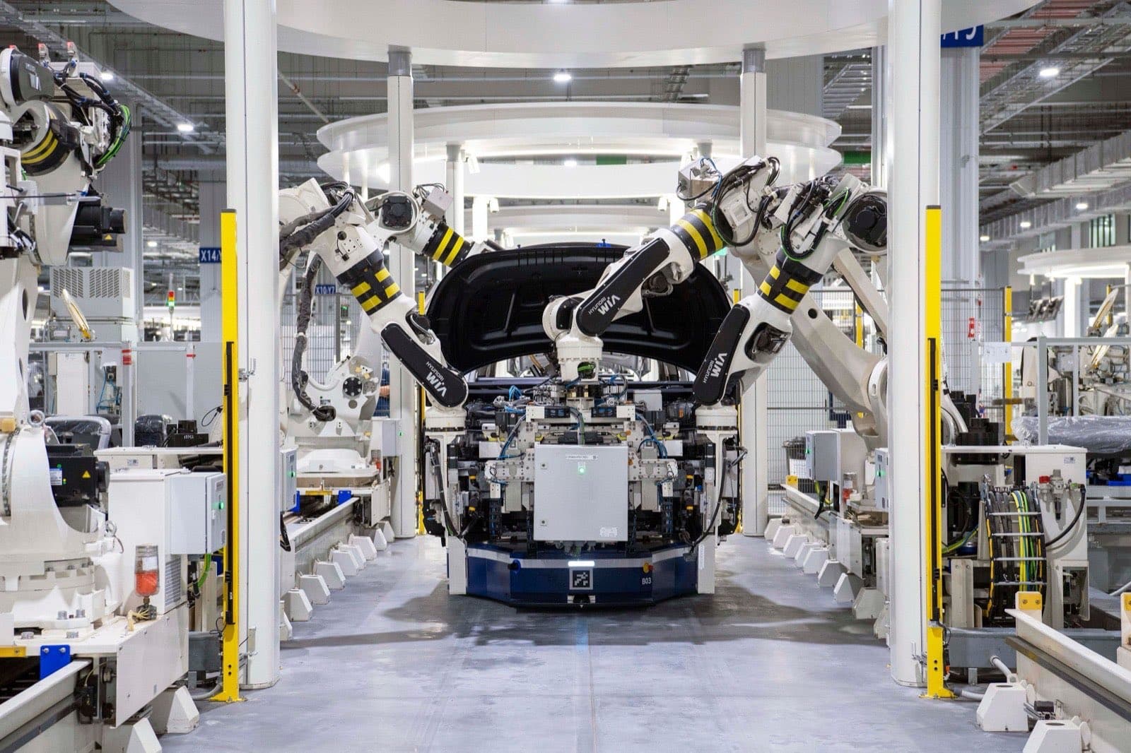 Automotive components moving along a factory assembly line, illustrating auto parts subject to a Section 232 tariff