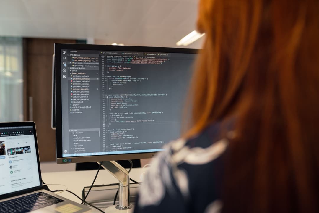 A developer reviewing JSON API output on a laptop while evaluating an HS code classification API