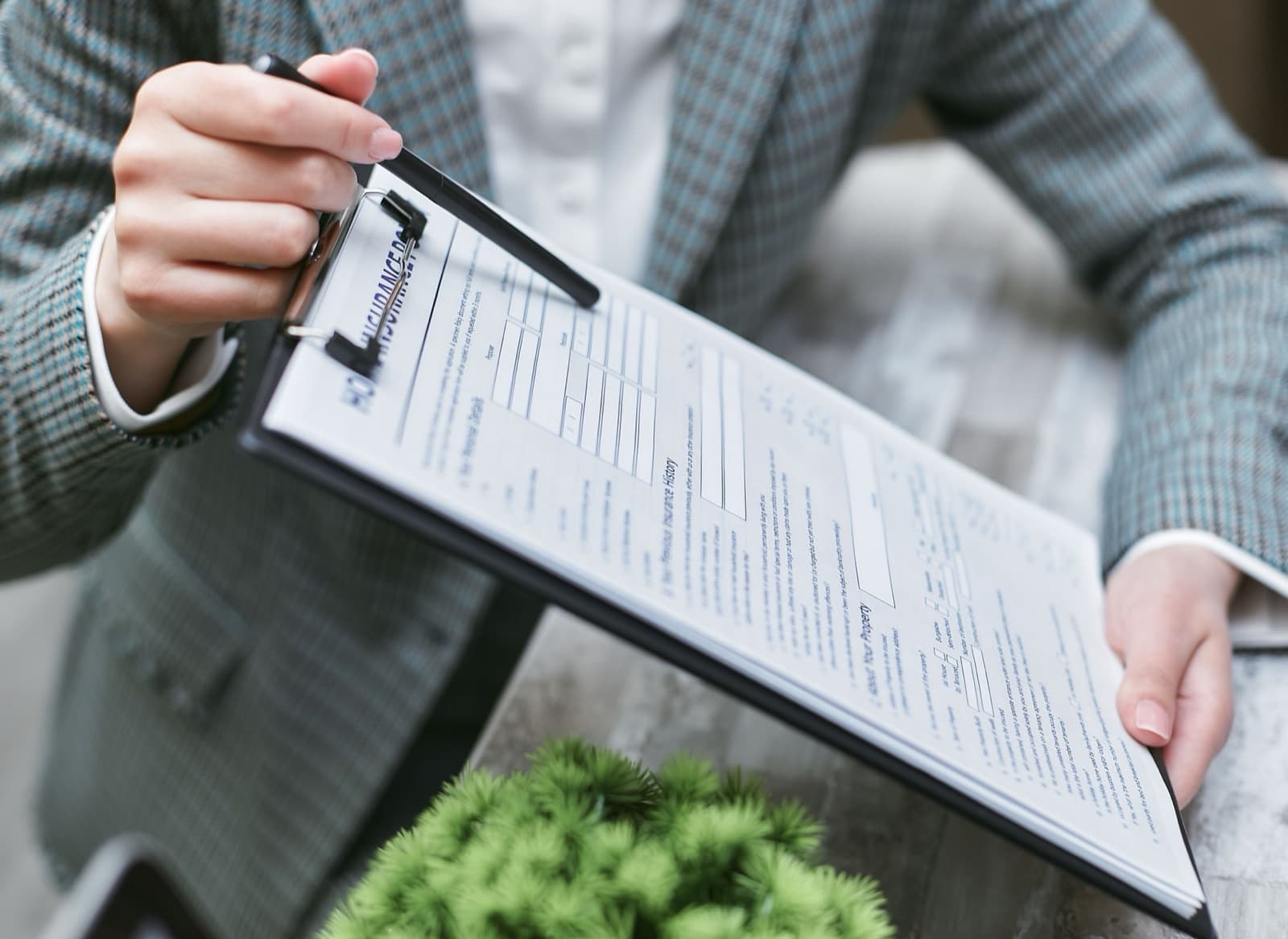 An insurance agent reviewing a surety bond policy document with a client, similar to arranging a continuous customs bond