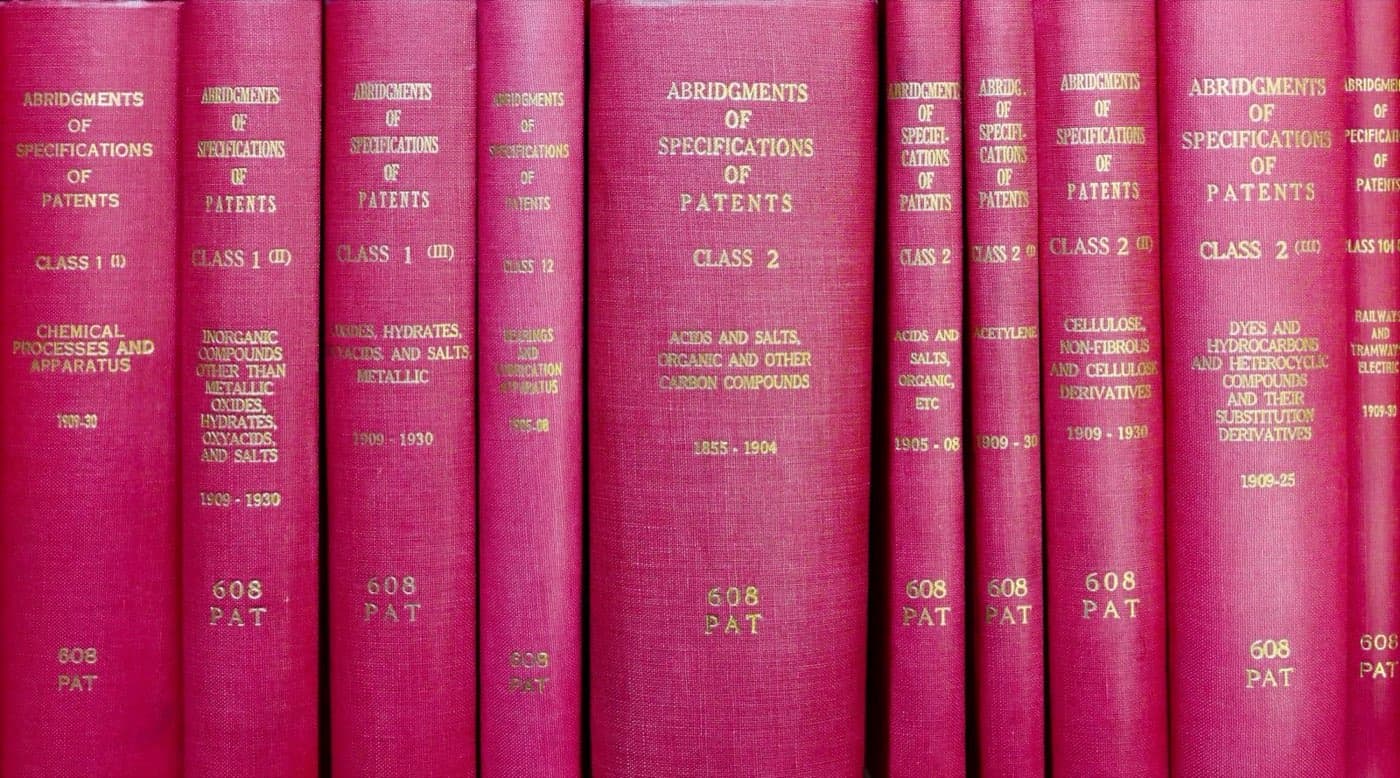 A row of bound reference volumes on a shelf, representing the layered structure of the Harmonized Tariff Schedule