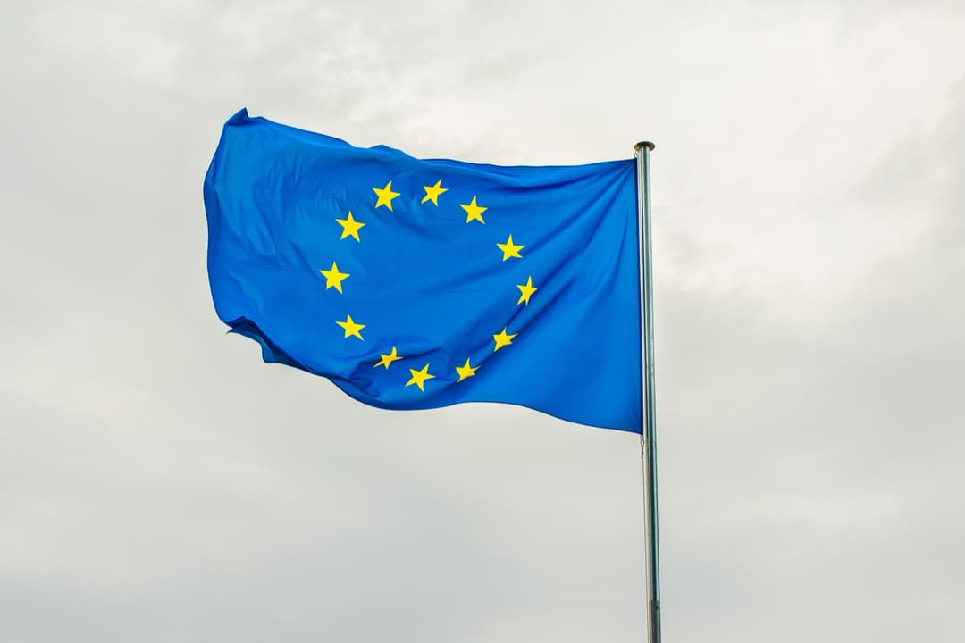 European Union flag flying against the sky, representing EU VAT and IOSS registration rules for cross-border sellers